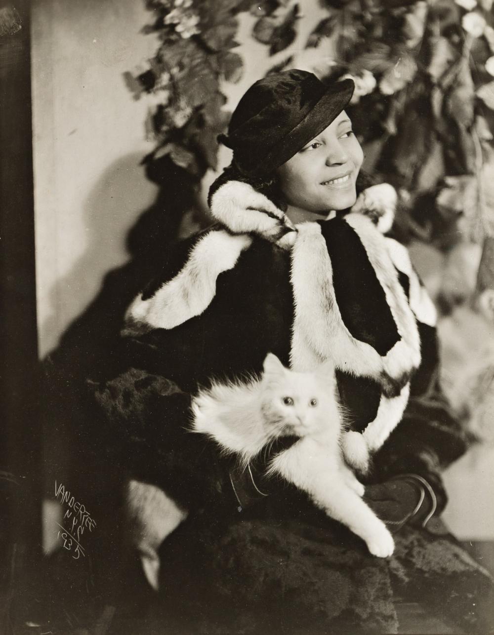 Woman in Fur Holding Cat